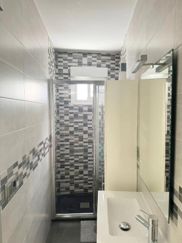 a white bathroom with a sink and a shower at Apto Pepi´s House in Sanxenxo