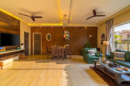 a living room with a couch and a table at Ekostay Gold - SUCASA VILLA - Games Room - Private Pool in Lonavala