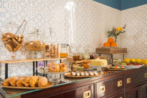 a buffet with many different types of bread and pastries at Family Affair Luxury Rooms&Suites in Palermo