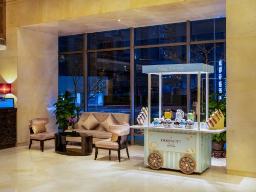 a dessert cart in the lobby of a building at Dorsett Chengdu in Chengdu