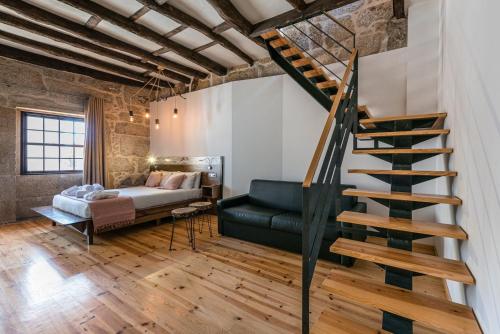 a living room with a staircase and a couch at GuestReady - CastleRock Pub & Hotel in Porto