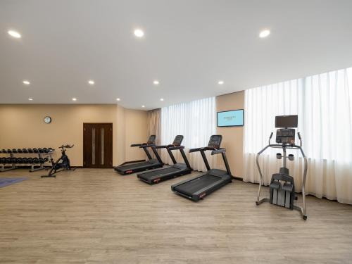 a gym with a row of treadmills and machines at Dorsett Chengdu in Chengdu