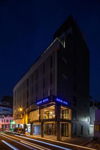 a building on a city street at night at BlueSky Hotel in Taichung