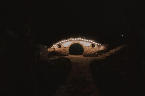 a tunnel with lights in the dark at Mobbiton Mostar - unique underground stay in Mostar