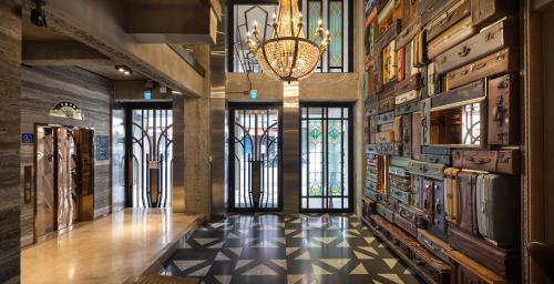 a hallway with a chandelier in a building with a floor at BlueSky Hotel in Taichung