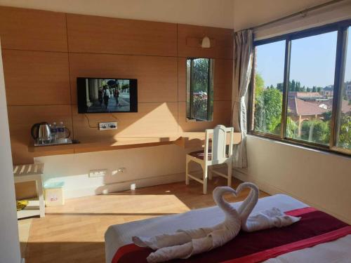 Postel nebo postele na pokoji v ubytování Hotel Ananda Inn
