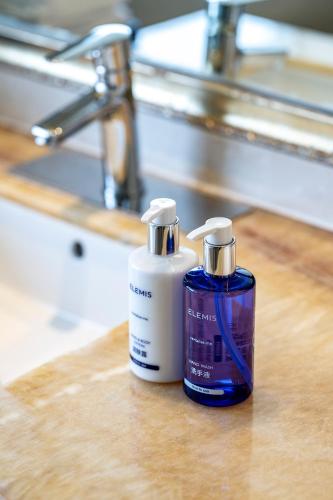 two bottles ofodorizers sitting on a wooden counter at Dorsett Chengdu in Chengdu