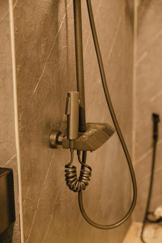 a lamp hanging on a wall in a bathroom at Halo Retreat in Hòa Bình