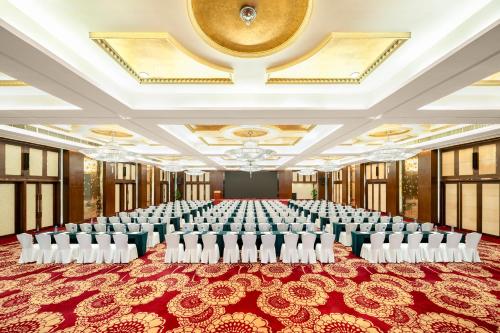 a large banquet hall with white chairs in a room at Dorsett Chengdu in Chengdu