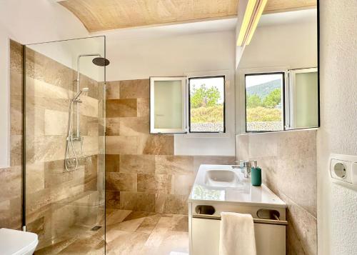 a bathroom with a sink and a shower at Villa Mimosa in Sant Josep de Sa Talaia