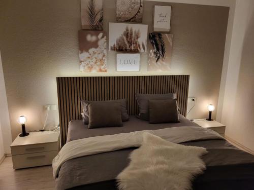 a bedroom with a large bed with two night stands at Moderne Ferienwohnung in Friedrichshafen