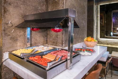 a grill with many different types of food on it at Hotel Forty One in Bucharest