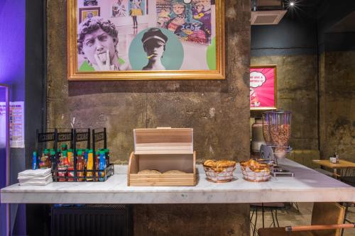a table with a box of bread and other items on it at Hotel Forty One in Bucharest