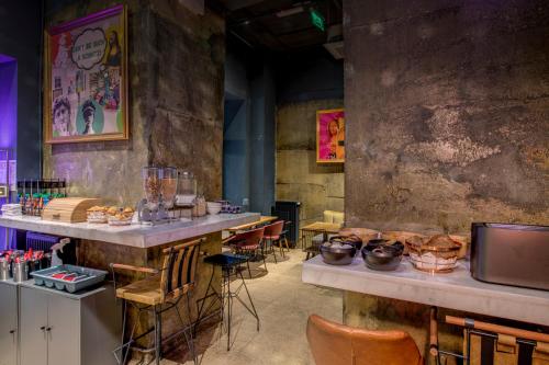 a restaurant with a bar with chairs and a table at Hotel Forty One in Bucharest