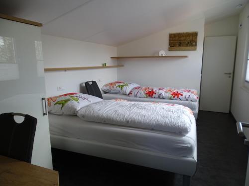 a room with two beds with pillows on them at Ferienapartment Birkenhain in Wettringen