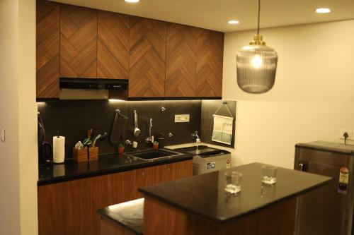a kitchen with a sink and a counter top at Sree Dhanya Vantage point in Trivandrum