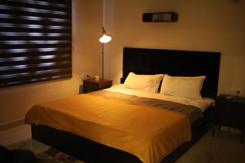 a bedroom with a large bed with a large window at Sree Dhanya Vantage point in Trivandrum