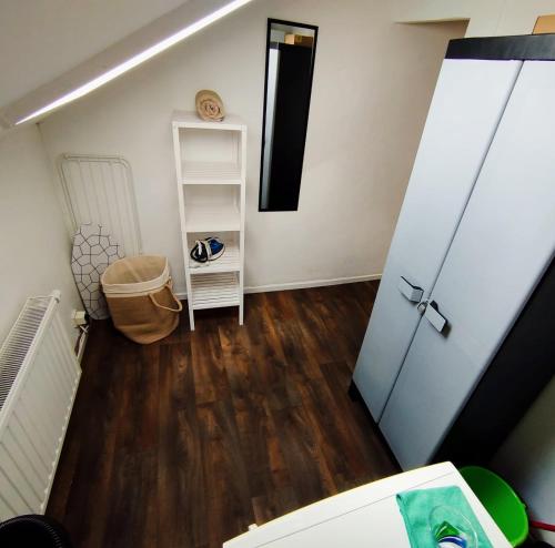 a room with a door and a wooden floor at Révélation Liège in Liège