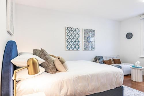 a white bedroom with a bed and a couch at Stylish Studio near the City Centre in Sydney