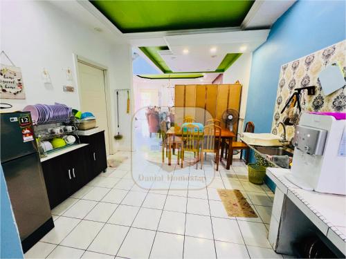 a kitchen with a table and a dining room at Danial Homestay Semporna in Semporna