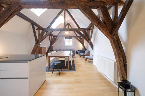 a kitchen and dining room with wooden beams at The Doms Flats in Brussels