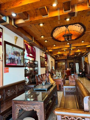 a restaurant with a bar with wooden ceilings and chairs at Hoàng Khiêm Hotel in Pleiku