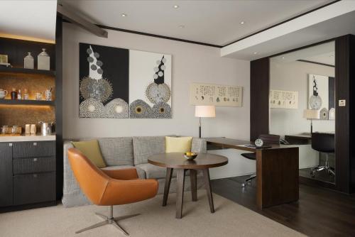 a living room with a couch and a table at Rosewood Beijing in Beijing