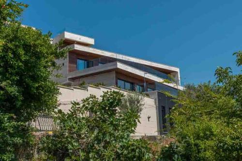 a house on a hill with trees at MonteLux Mansion in Tivat