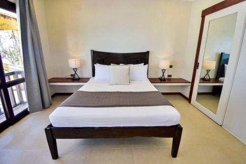 a bedroom with a large bed in a room at Hey Jude Bulabog Beachfront Residence in Boracay