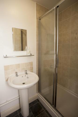 a bathroom with a sink and a shower at The Five Bells in Deal