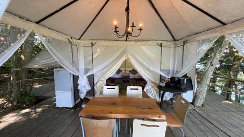 a tent with a table and chairs in it at Shimanto Yamamizuki - Vacation STAY 36959v in Shimanto