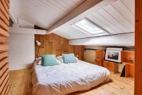 a bedroom with a large bed with blue pillows at Maison pour 2 adultes - 4 enfants - 600m plage in Le Fier