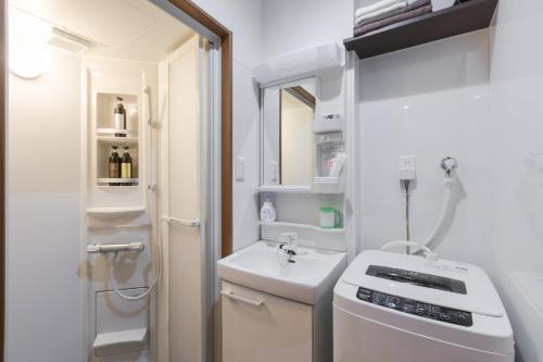 a small white bathroom with a sink and a toilet at Kyoto - apartment / Vacation STAY 168 in Kyoto