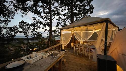 a gazebo on a deck with a table and chairs at Shimanto Yamamizuki - Vacation STAY 36960v in Shimanto