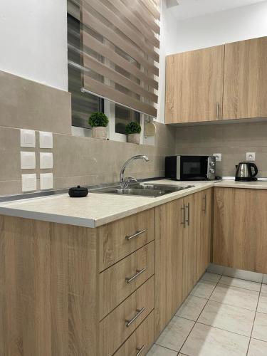 a kitchen with a sink and a microwave at Villa Flora in Afantou