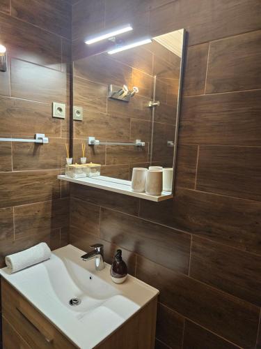 a bathroom with a sink and a mirror at Villa Szófia in Siófok