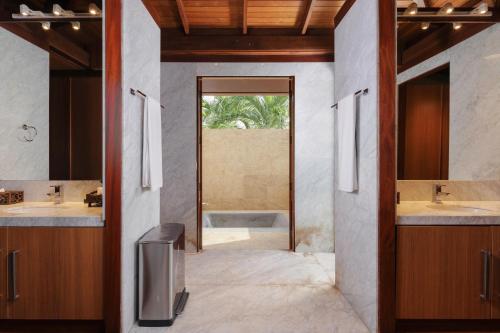 a bathroom with two sinks and a tub at Luxury 4 pool Seaview 6 bedroom Villa on Surin Hill in Surin Beach