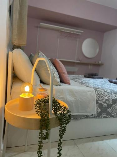 a bedroom with a bed and a table with a lamp at Villa Flora in Afantou