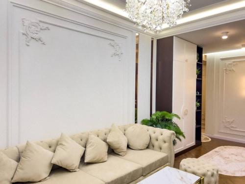 a living room with a white couch and a chandelier at Modern Lux 2 in Samarkand