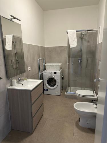 a bathroom with a washing machine and a washer at CA DEL TRIMA in Melegnano