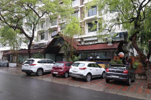 a group of cars parked in front of a building at Hotel Heritage 2001, Nagpur in Nagpur