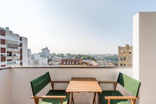 a table and chairs on a balcony with a view at GuestReady - Urban escape with a view in Porto