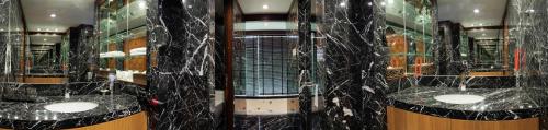 a bathroom with black marble counters and mirrors at Luxury 4 pool Seaview 6 bedroom Villa on Surin Hill in Surin Beach