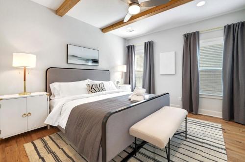 a bedroom with a large bed and a chair at The Oakley - Near Lake Fayetteville in Fayetteville