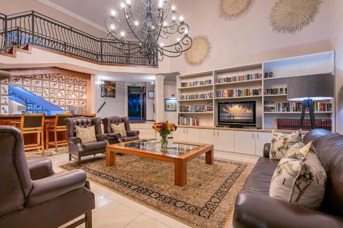 a living room with couches and a coffee table at Hyde Park Guest House in Johannesburg