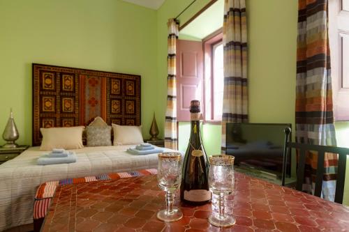 a bedroom with a bed and a bottle of wine on a table at Casa da Moura in Lagos