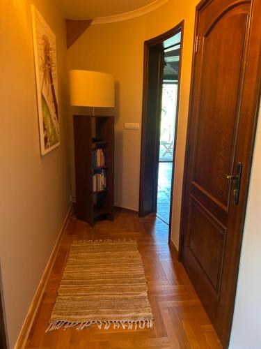 a hallway with a door and a rug on the floor at Pod Lasem in Nowy Targ