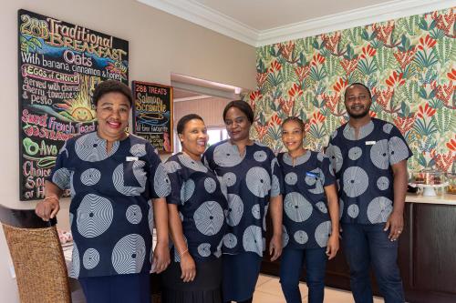 a group of people in tshirts posing for a picture at Hyde Park Guest House in Johannesburg