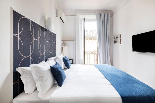 Cama o camas de una habitación en Easylife - Suite in Porta Venezia
