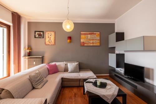 a living room with a couch and a tv at TURIN CENTER whit PRIVATE PARKING in Turin